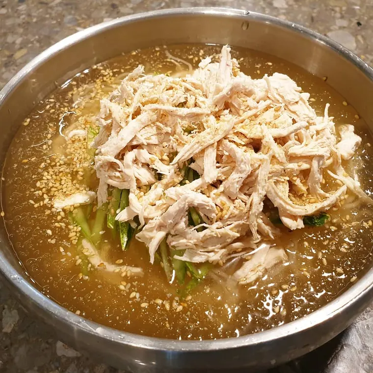 초계국수. 결대로 찢은 닭고기와 국수가 시원한 육수에 담겨 있다.